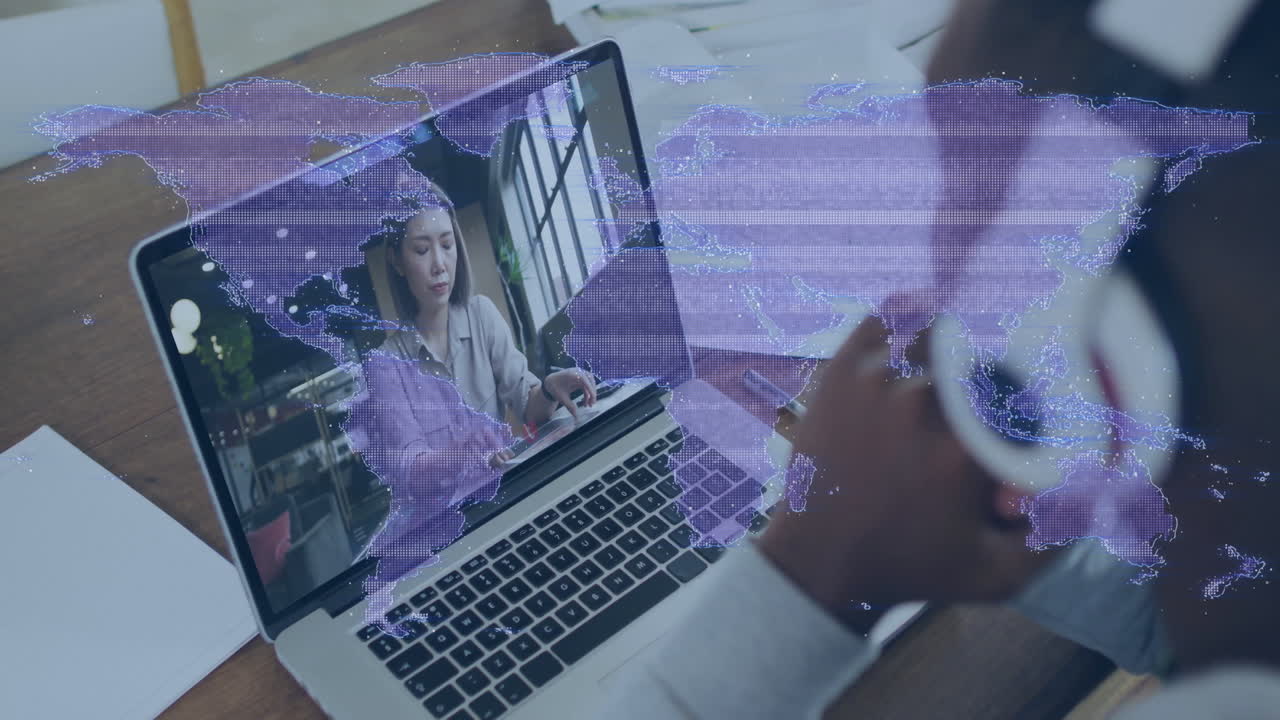 Laptop displaying virtual meeting with global network animation in home office