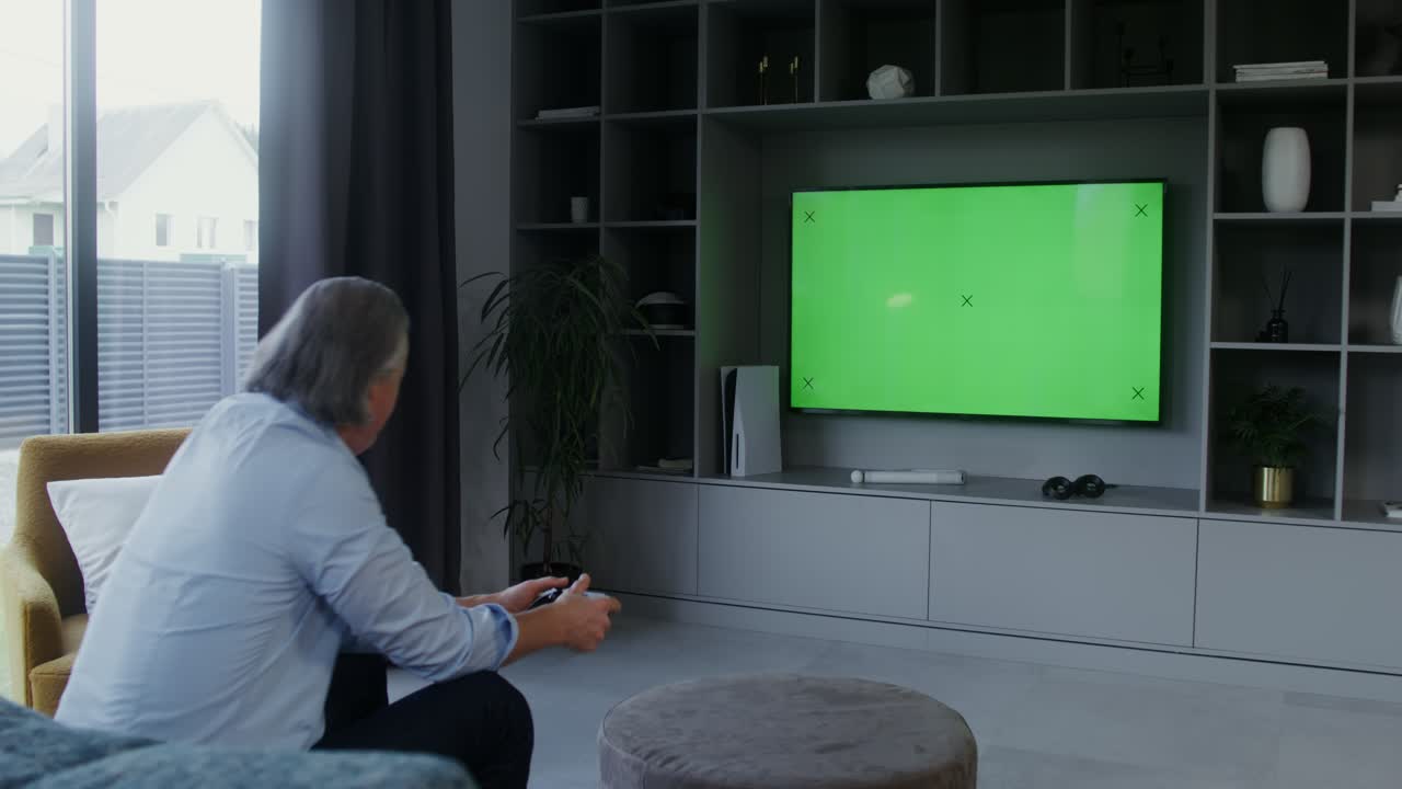 Man Playing Video Game on TV with Green Screen