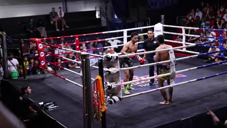 intense muay thai fight with cheering crowd