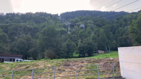 gondolas leave lower station of cable car to eggishorn, aletsch glacier, switzerland