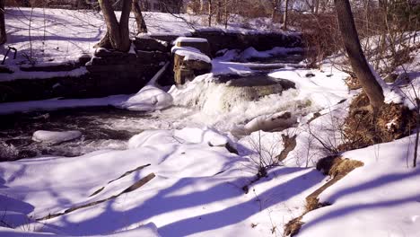 wide shot of royal river dam with offices in the background, ice flow in yarmouth, maine