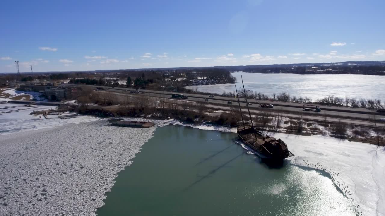 Wreck of La Grande Hermine ship and highway in Canada, aerial push-in