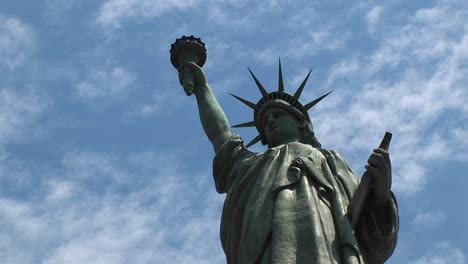 The-Statue-Of-Liberty-Proudly-Stands-Silhouetted-Against-A-Blue-Sky