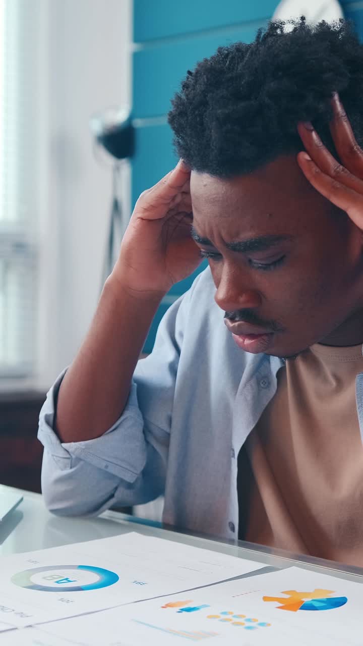 A young man experiences stress while studying for exams in a quiet room