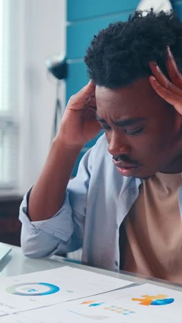 a young man experiences stress while studying for exams in a quiet room