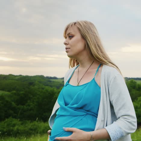 pregnant woman walking through countryside