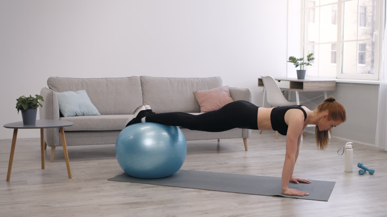 Woman doing Plank Exercise with Exercise Ball at Home