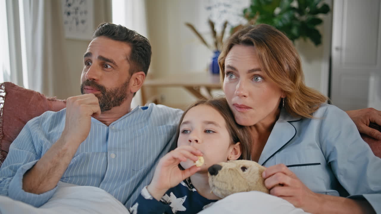 Family viewers laughing comedy on tv sitting couch closeup. People looking movie