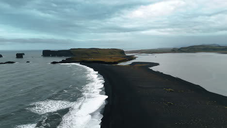 narrow line of black beach with volcanic sand. nordic severe scenery of iceland from aerial view.