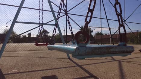 two empty swings for kids in the summe