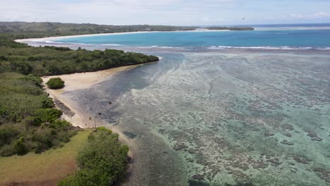 Amazing-aerial-vista-of-Natadola-Beach-captured-by-a-drone,-revealing-pristine-sands,-turquoise-waters-and-coral-reef