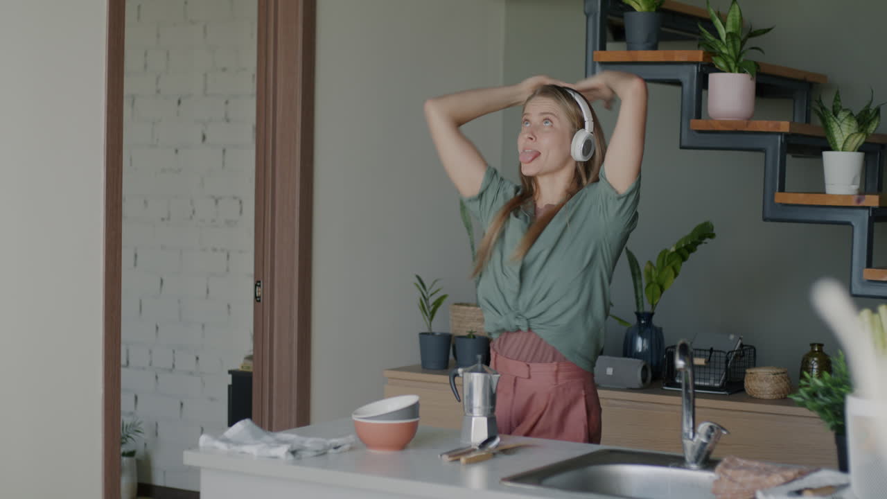 Woman Dancing in Kitchen with Headphones