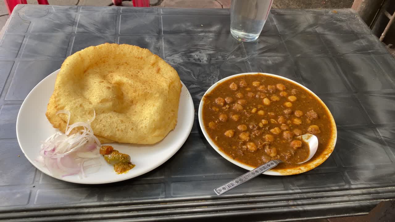 primer plano de la comida del desayuno indio delicioso plato indio: chole bhature o poori con curry chana masala de garbanzos