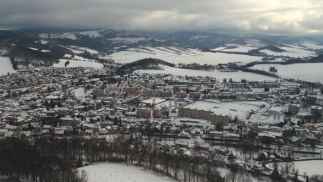 aerial view of the mountain town of jeseník in the valley below the jeseníky mountains