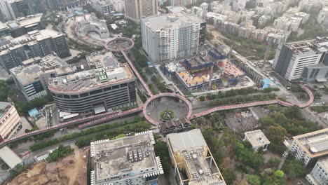 smooth drone pan over a multilane highway passing beside office buildings