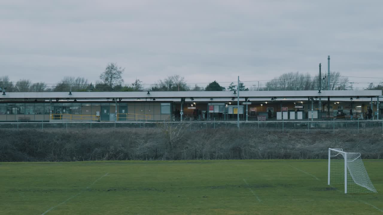 회색 흐린 날 배경에 엘리 기차역이 있는 애머스트 필드의 패닝 샷