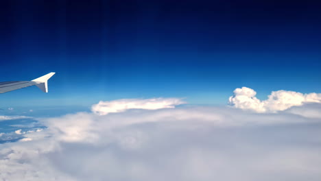stunning view of smoky, dense clouds from airplane during daytime. airplane wing.