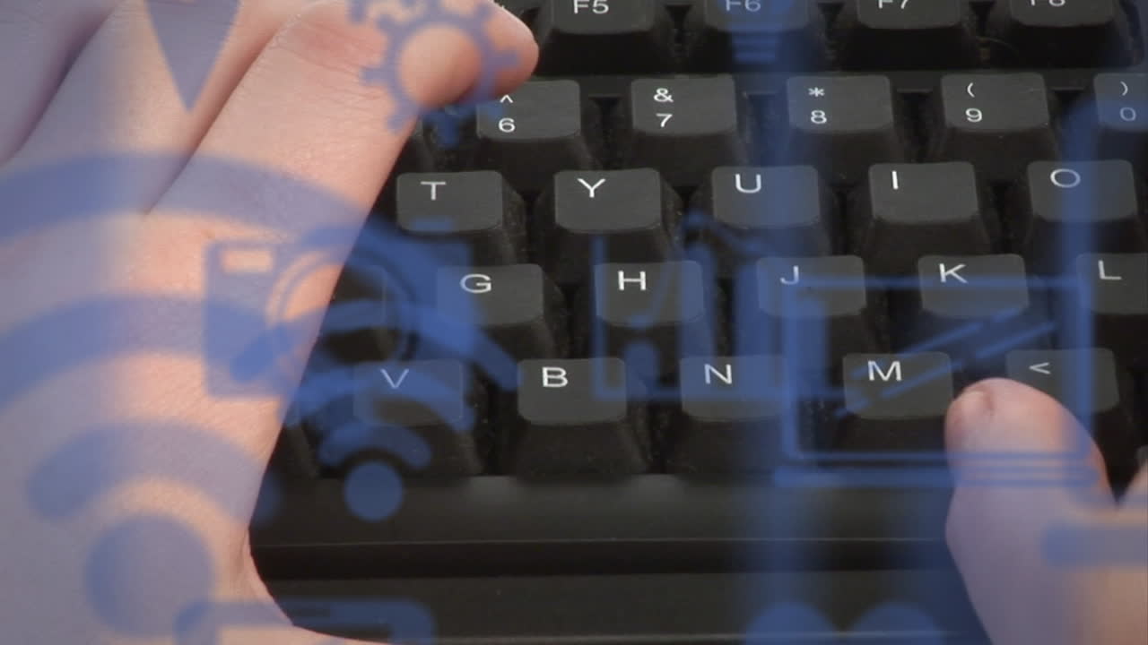 Animation of technology icons over caucasian man typing on keyboard