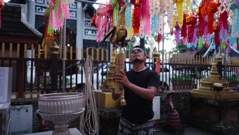 man preparing for a religious ceremony at a thai temple