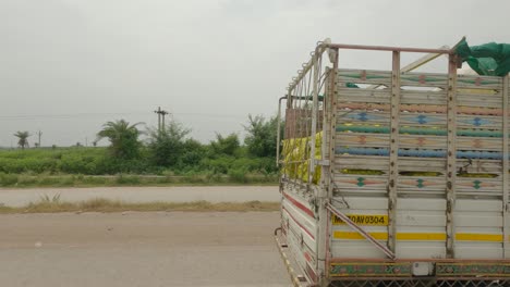 Side-angle-of-a-vehicle-overtaking-light-commercial-vehicle-passing-through-national-highway-in-Maharashtra