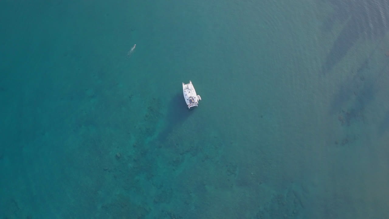 vista de punto de interés de drones del yate en agua de mar azul en una isla tropical en un día soleado