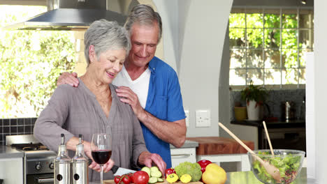 happy senior couple making a salad