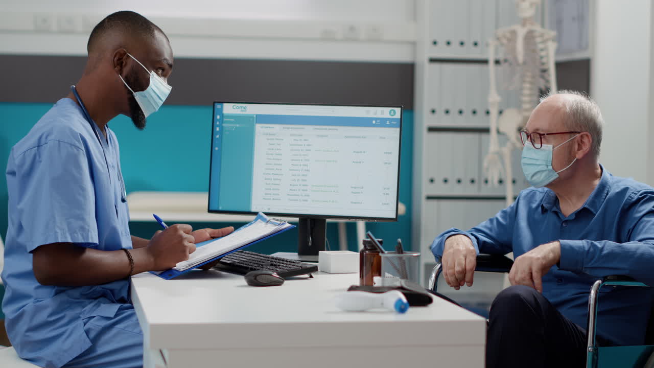 Doctor Consulting with Patient in Wheelchair