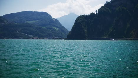 peaceful view sail boats moving on mountain lake - hergiswil switzerland mountains in 4k