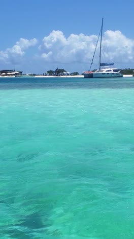 vertical view from a boat sailing on calm turquoise waters in the caribbean, off venezuela.