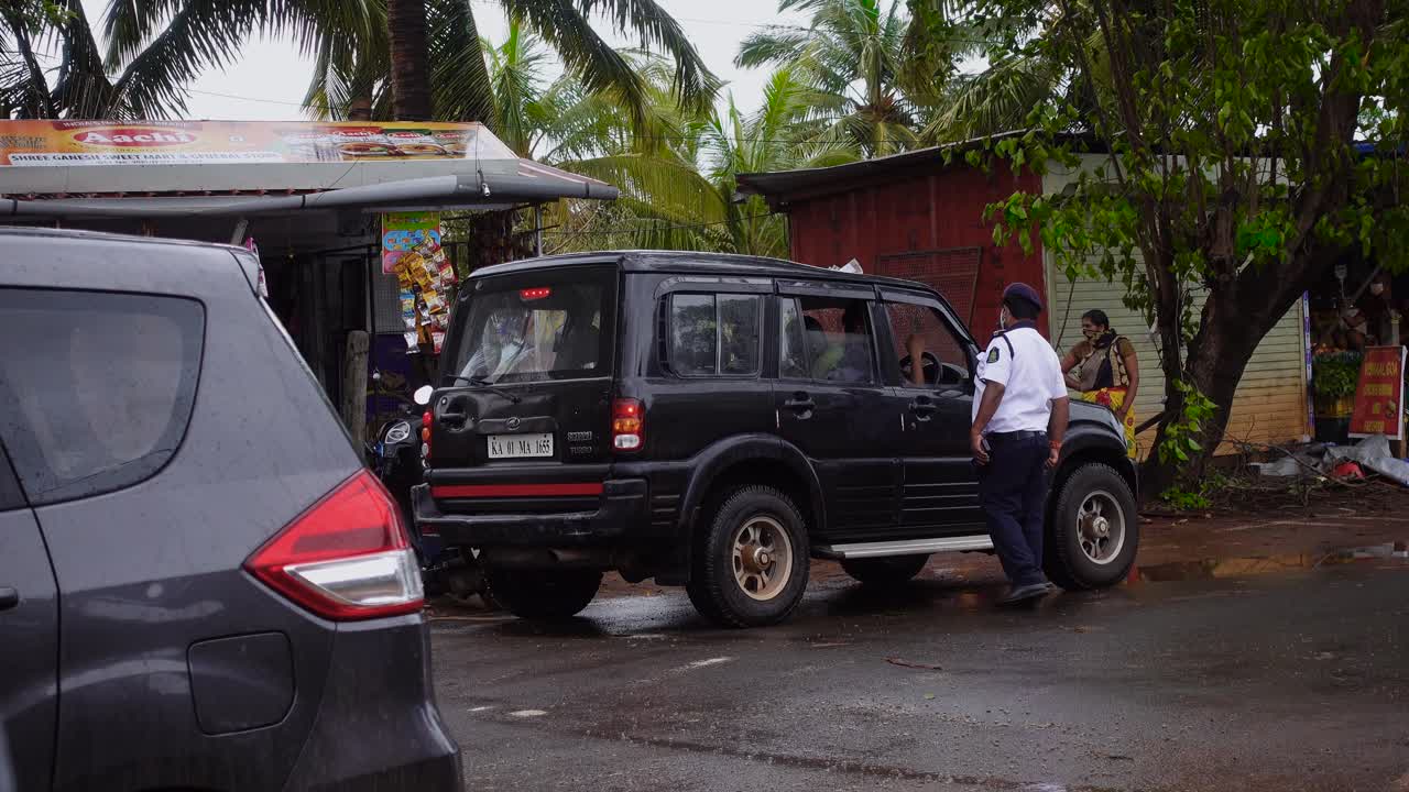 Indian Police Officer Speaks to Driver Through Window at Roadside Traffic Stop