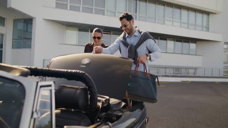 couple getting in/out of a classic car