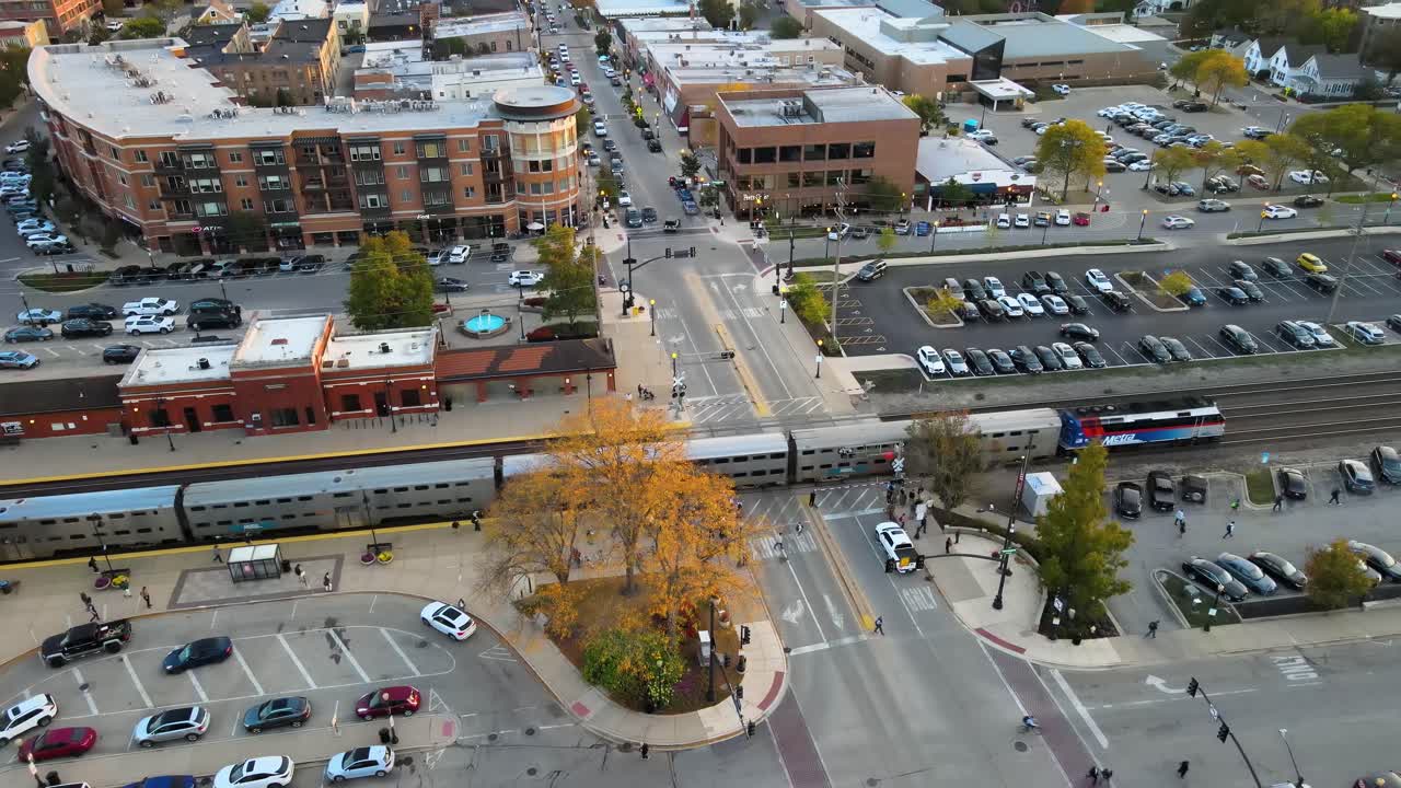 Commuter train crossing through Downers Grove Illinois train station at sunset. Crane Down Sunset S
