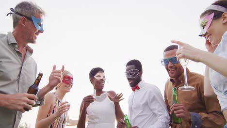 portrait of happy african american married couple with diverse friends drinking wine