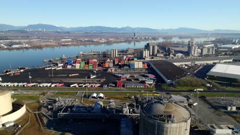 aerial view of fortisbc tilbury lng plant and fraser river in tilbury island, delta, bc, canada. - pullback shot