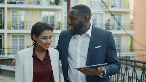 Happy-business-couple-getting-news-on-tablet-computer.-Team-celebrating-success