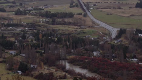 a new zealand village in the rain wide view from a distant mountain