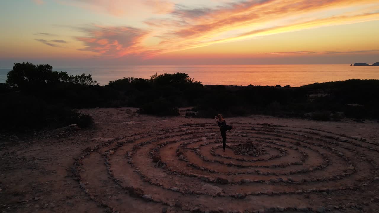 Drone shot time space on ground with spiral coiled stones with twilight sky
