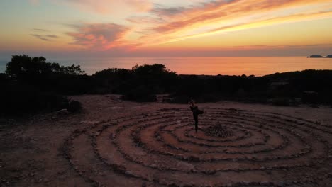 Drone-shot-time-space-on-ground-with-spiral-coiled-stones-with-twilight-sky