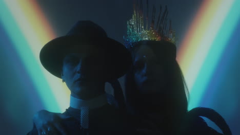 portrait of gothic queen and priest in dark studio
