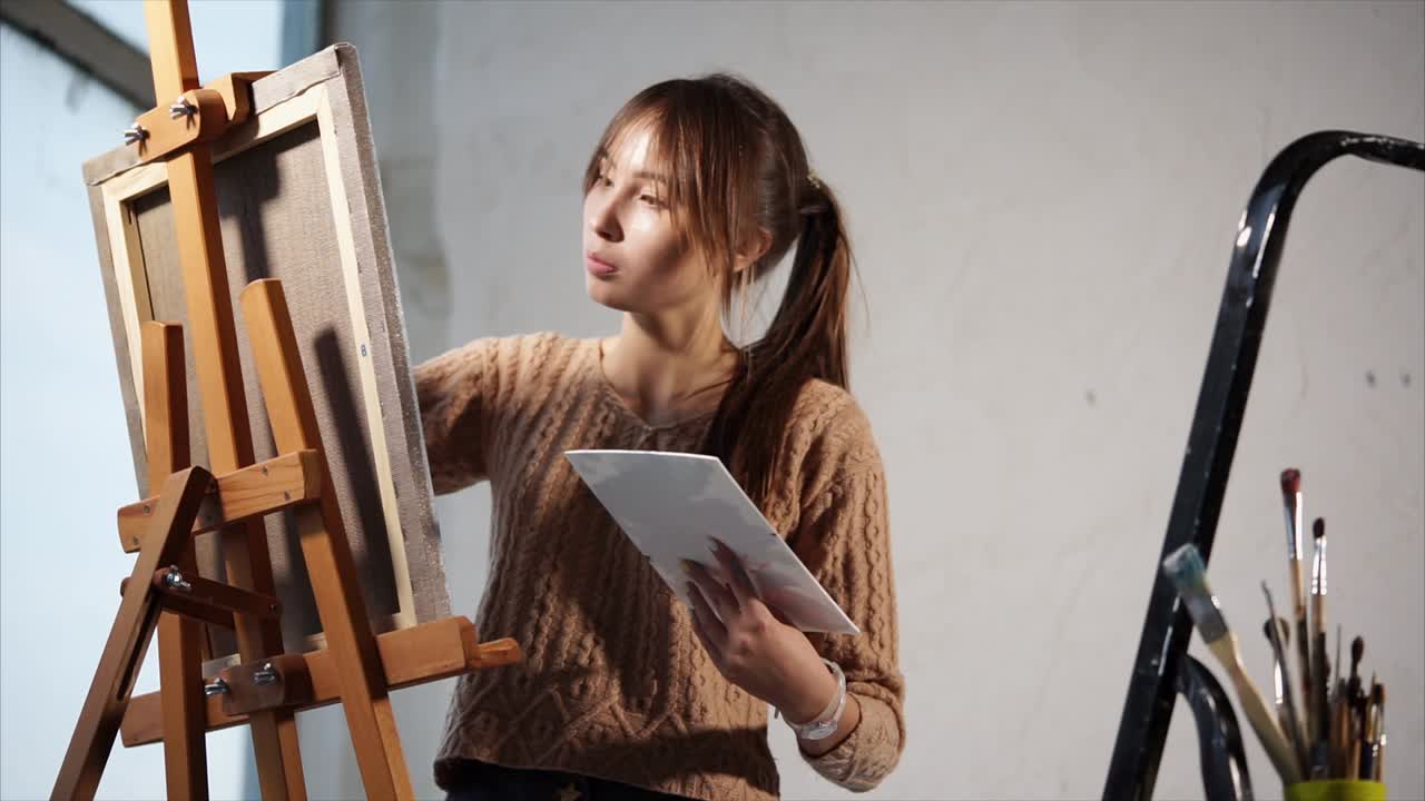 Teenage Girl Painting in Studio