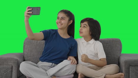 Happy-Indian-sibling-making-a-video-for-social-media-Green-screen