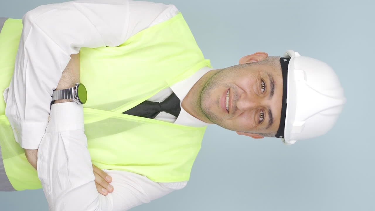 vídeo vertical del ingeniero con un casco de seguridad y sonriendo.