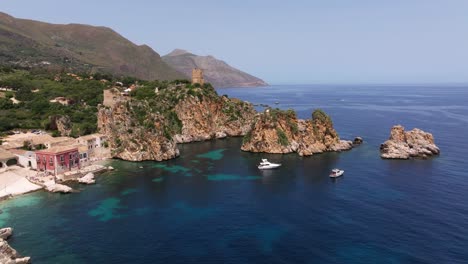 Cinematic-Drone-Flight-Above-Tonnara-di-Scopello,-Scopello-Tower,-and-Scopello-Stacks