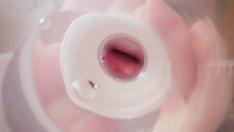 little child drinks water from transparent plastic bottle