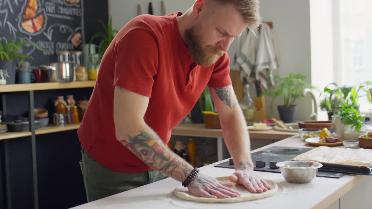 Chef Flattening Dough for Baking Pizza