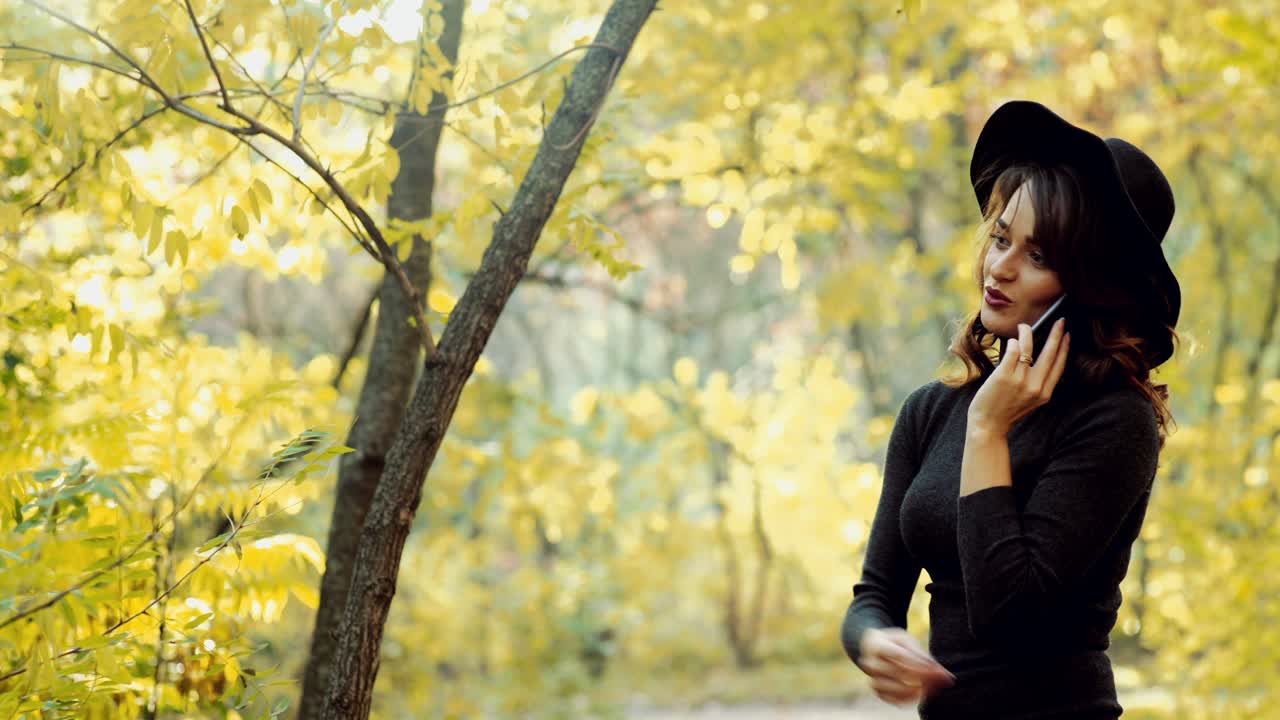 Woman posing in park. Happy young woman posing in autumn park