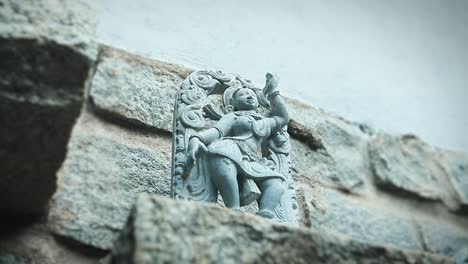 carving of indian woman dancing. handheld, low angle