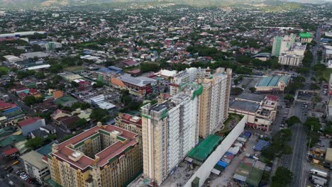 aerial view of sienna towers - high-rise condominium buildings in marikina city, philippines. ascending pullback shot