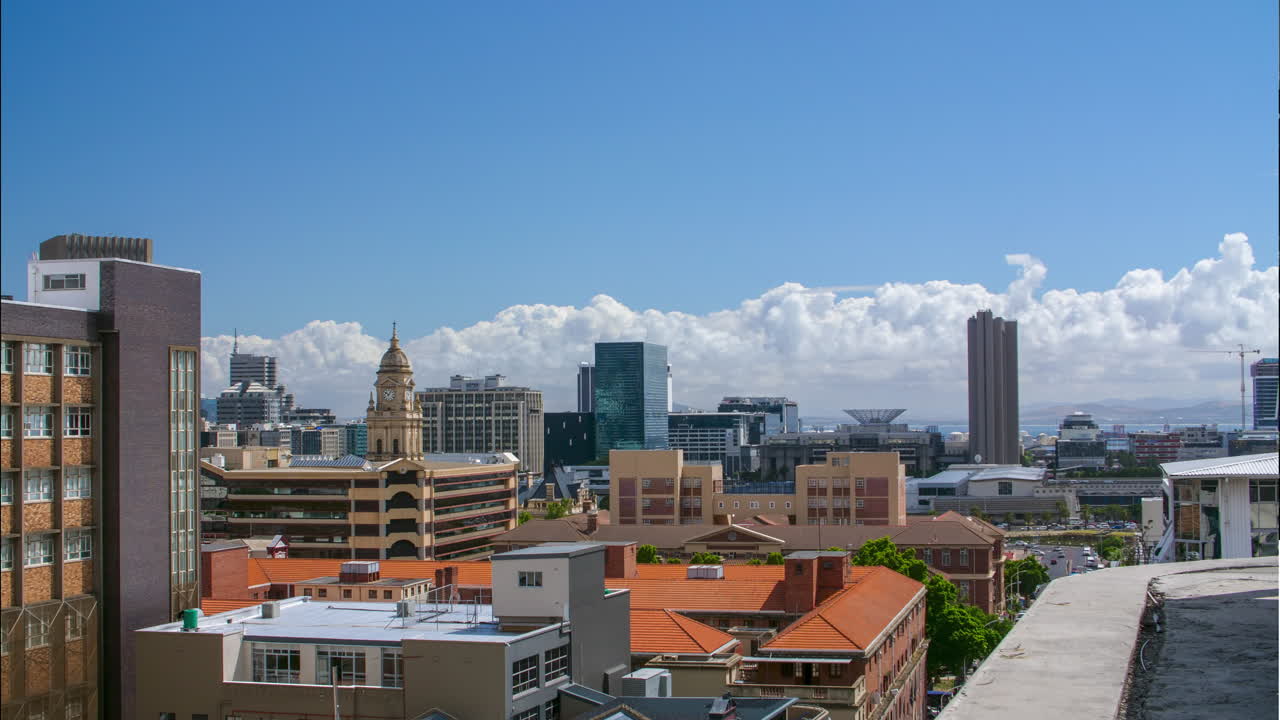 Cityscape time lapse of Cape Town CBD in summer with big cloud patterns over bay