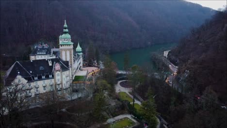 drone shot of a hungarian castle with the view of a lake in autumn